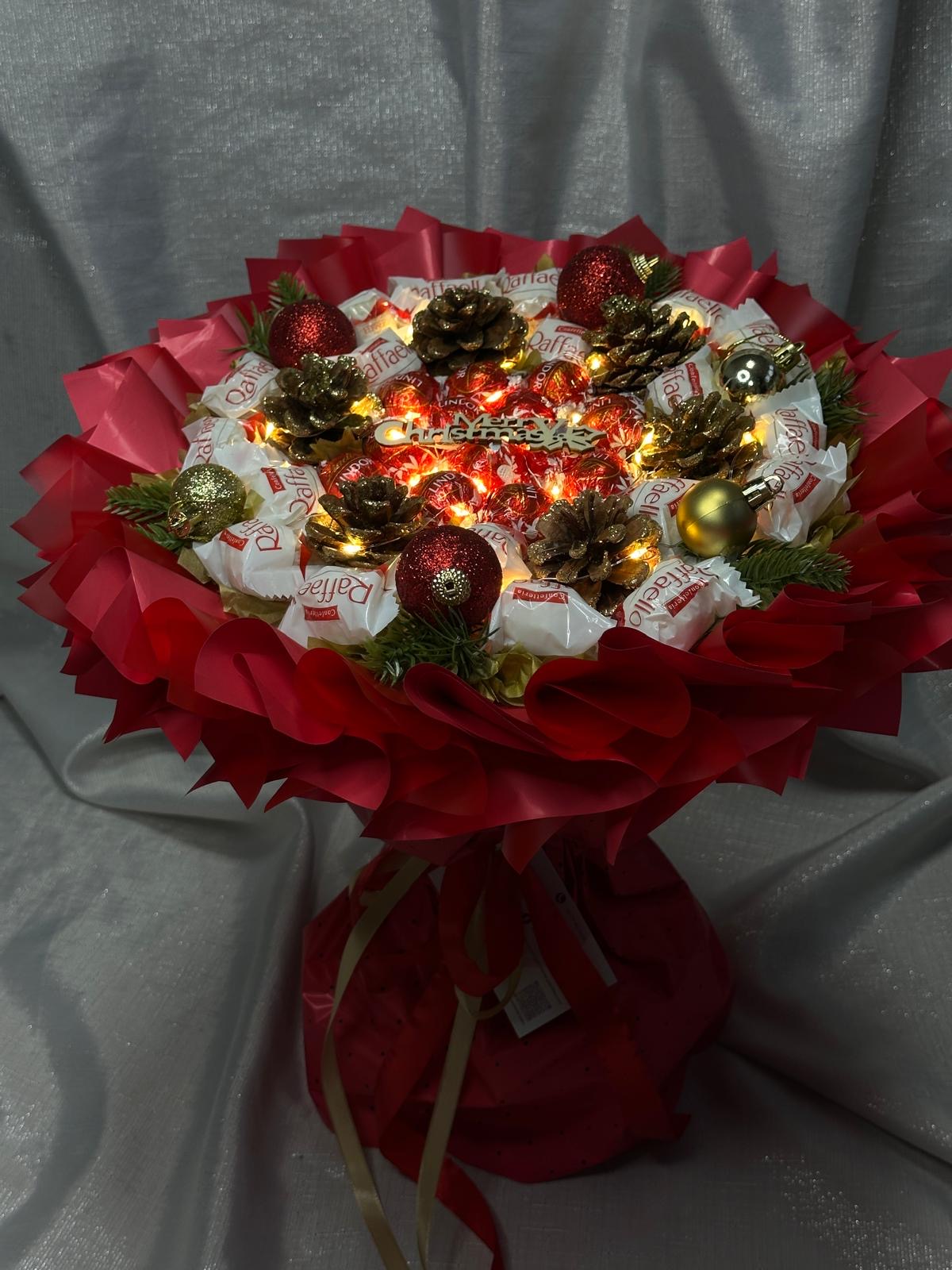 Leutender Weihnachtsstrauß mit Pralinen