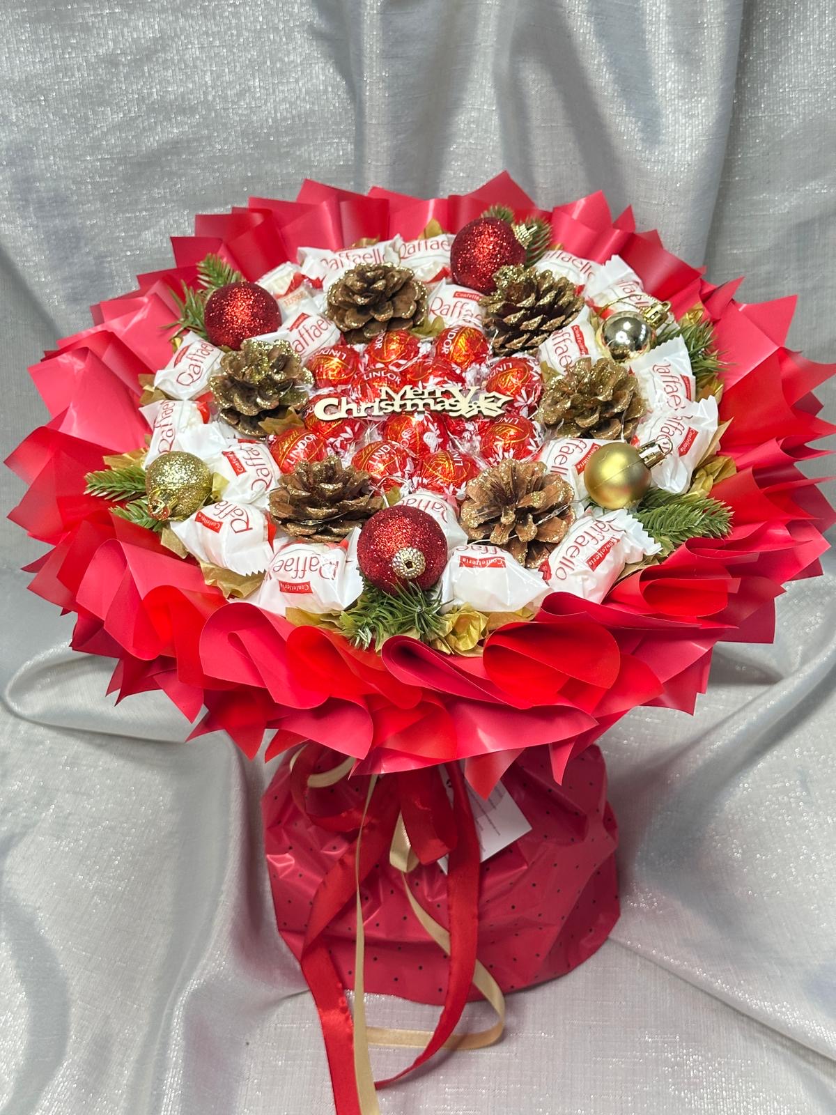 Leutender Weihnachtsstrauß mit Pralinen