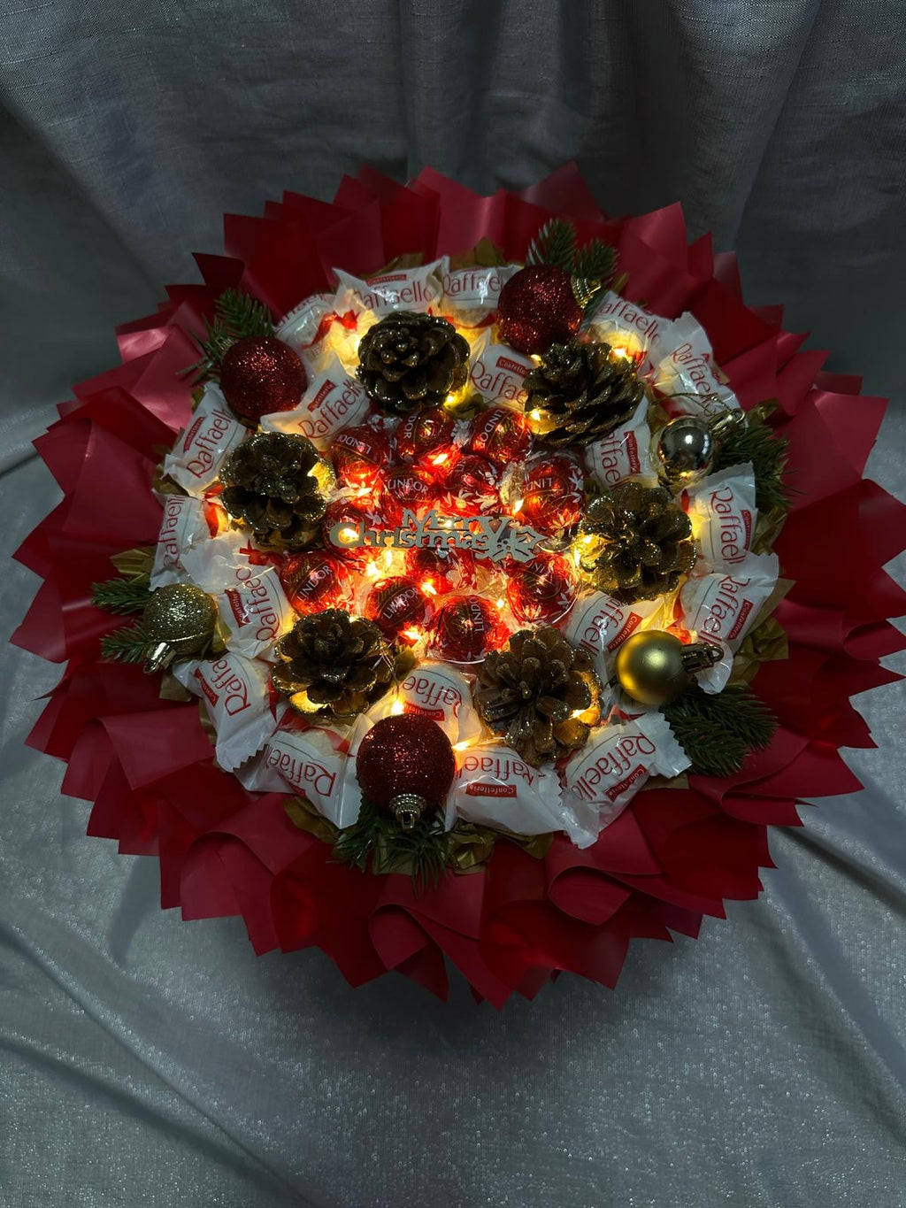 Leutender Weihnachtsstrauß mit Pralinen