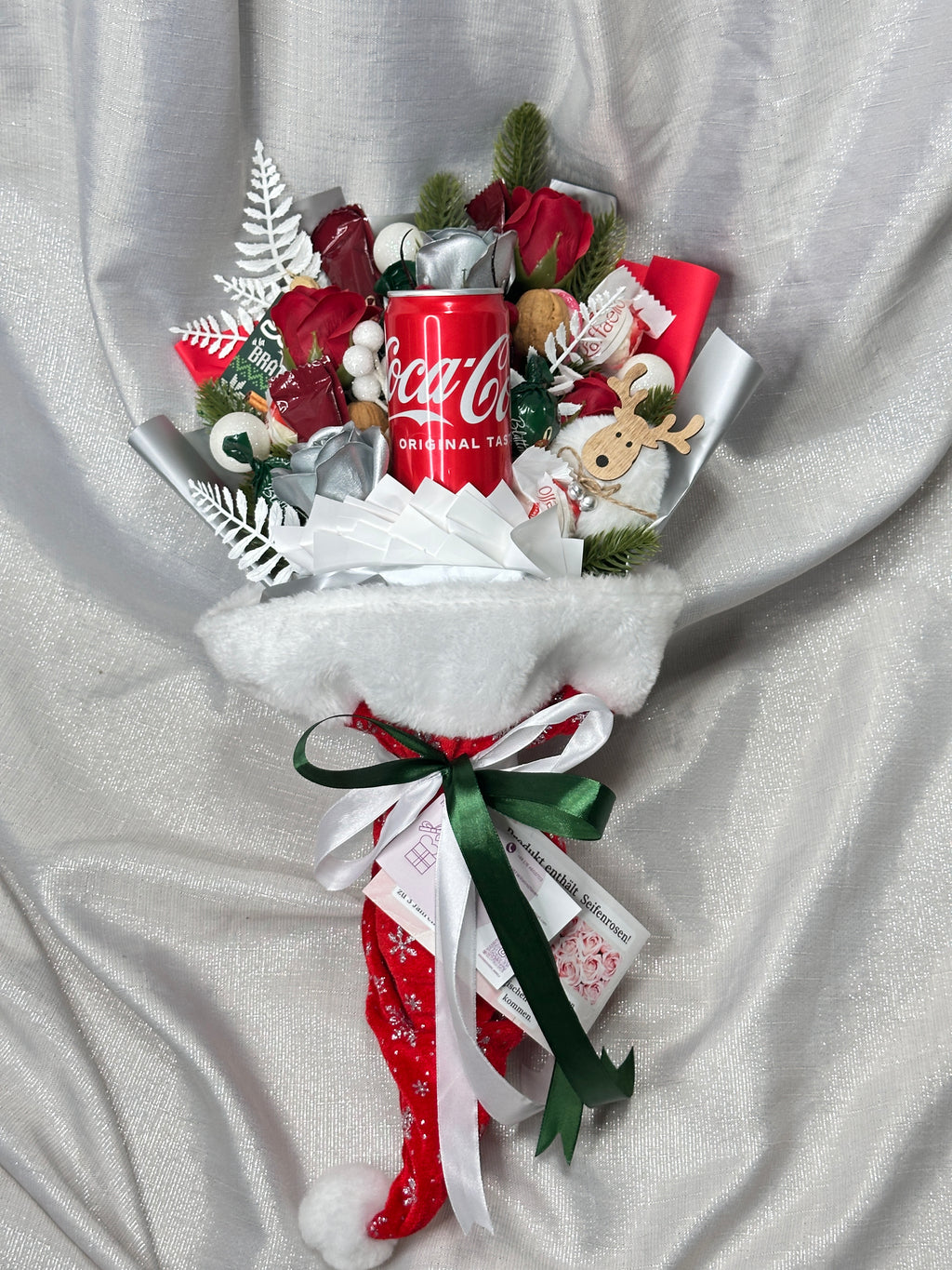 Strauß in Weihnachtsmütze mit verschienen Süßigkeiten